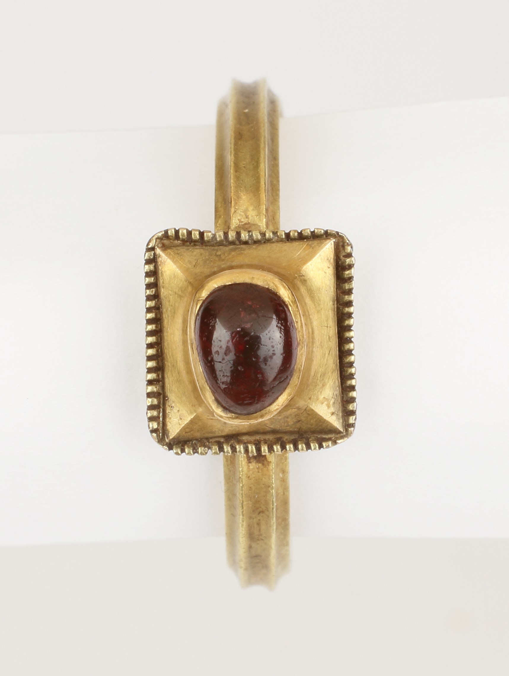 A Fine Medieval Finger-Ring set with a Cabochon Garnet